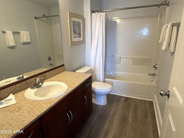 full bath with wood finished floors, shower / bath combo with shower curtain, toilet, and vanity