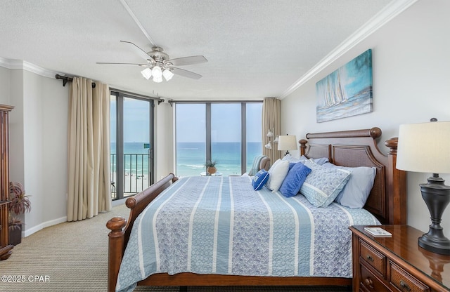 11619 Front Bch Unit 610, Panama City Beach, FL 32407 - bedroom with access to outside, a water view, a textured ceiling, crown molding, and light colored carpet