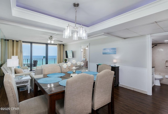 11619 Front Bch Unit 610, Panama City Beach, FL 32407 - dining area featuring wood finished floors, ceiling fan, a wainscoted wall, and crown molding