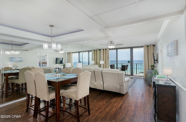 11619 Front Bch Unit 610, Panama City Beach, FL 32407 - dining area featuring ceiling fan, dark wood-style floors, crown molding, a chandelier, and a tray ceiling