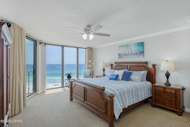 11619 Front Bch Unit 610, Panama City Beach, FL 32407 - bedroom with access to outside, light carpet, a textured ceiling, a water view, and ornamental molding
