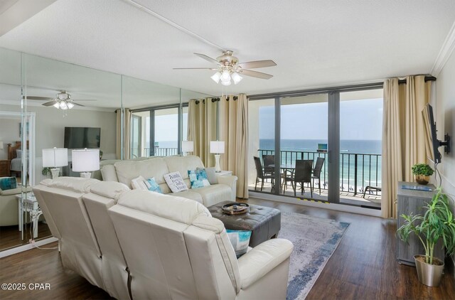 11619 Front Bch Unit 610, Panama City Beach, FL 32407 - living area featuring ceiling fan, wood finished floors, expansive windows, and ornamental molding