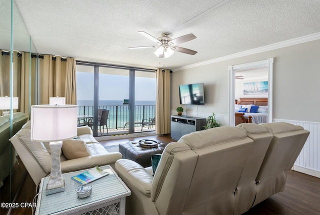 11619 Front Bch Unit 610, Panama City Beach, FL 32407 - living room with a textured ceiling, ceiling fan, dark wood-type flooring, crown molding, and wainscoting