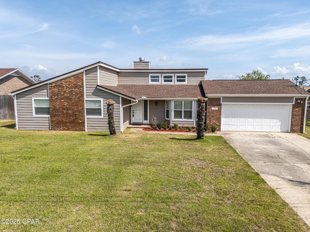 3184 Wood Valley Rd, Panama City, FL 32405 - view of front of house featuring concrete driveway, an attached garage, brick siding, and a front yard