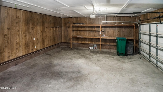 garage with wooden walls and a garage door opener