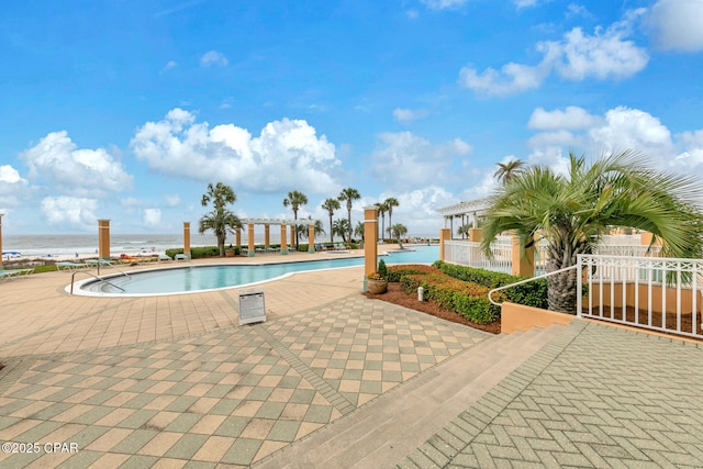7505 Thomas Dr Unit 512B, Panama City, FL 32408 - community pool featuring a pergola, a patio area, a water view, and fence