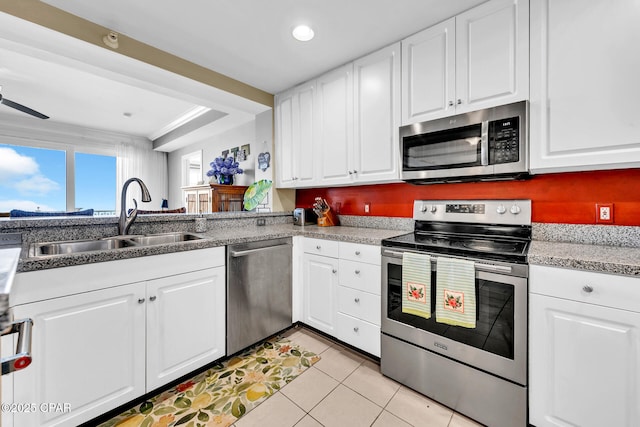 7505 Thomas Dr Unit 512B, Panama City, FL 32408 - kitchen featuring stainless steel appliances, a sink, light tile patterned flooring, white cabinetry, and recessed lighting
