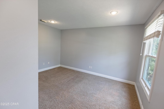 empty room with recessed lighting, carpet floors, visible vents, and baseboards