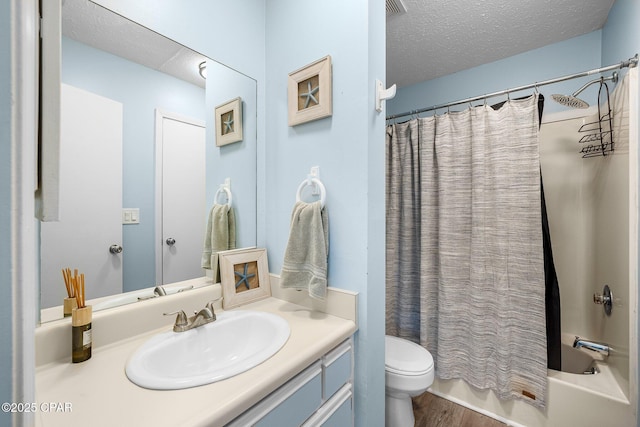 171 Damon Cir, Panama City Beach, FL 32407 - bathroom with toilet, a textured ceiling, vanity, wood finished floors, and shower / bath combo