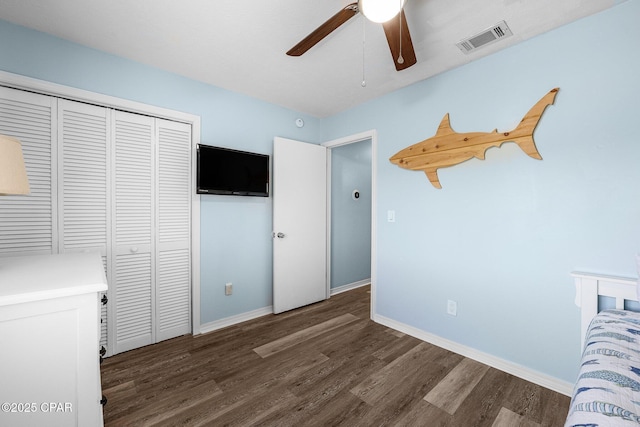171 Damon Cir, Panama City Beach, FL 32407 - unfurnished bedroom featuring wood finished floors, a closet, baseboards, and a ceiling fan