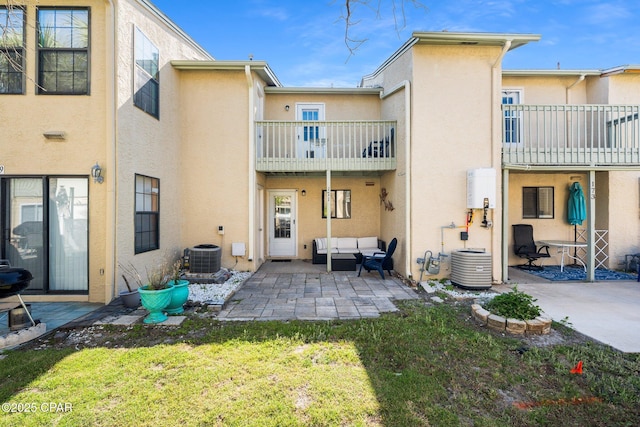 171 Damon Cir, Panama City Beach, FL 32407 - back of property with a balcony, stucco siding, outdoor lounge area, a patio area, and a yard