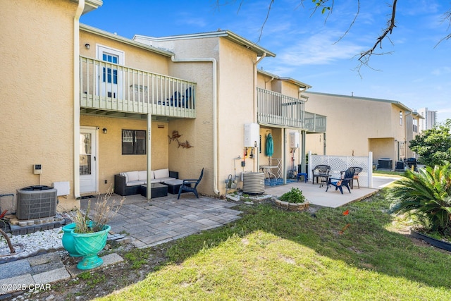 171 Damon Cir, Panama City Beach, FL 32407 - rear view of house with a balcony, stucco siding, a patio area, and an outdoor hangout area