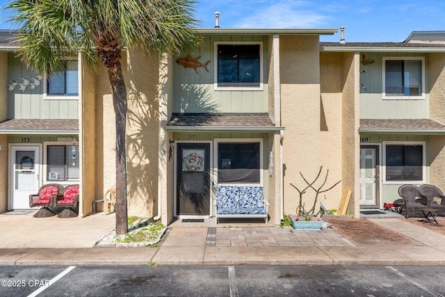 171 Damon Cir, Panama City Beach, FL 32407 - view of front of house featuring stucco siding and roof with shingles