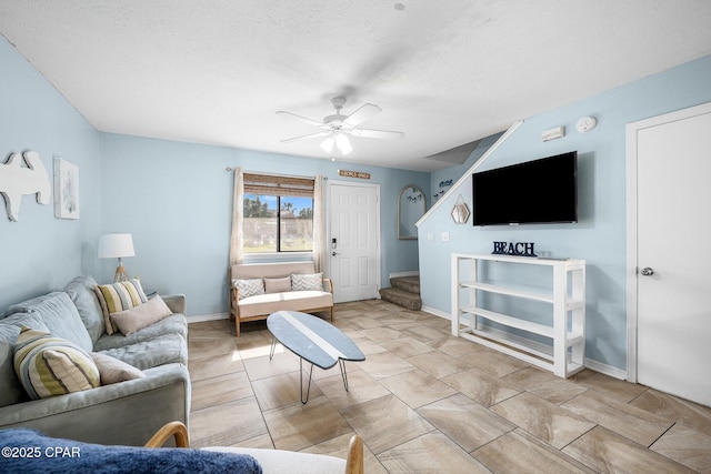 171 Damon Cir, Panama City Beach, FL 32407 - living area with stairway, a ceiling fan, baseboards, and a textured ceiling