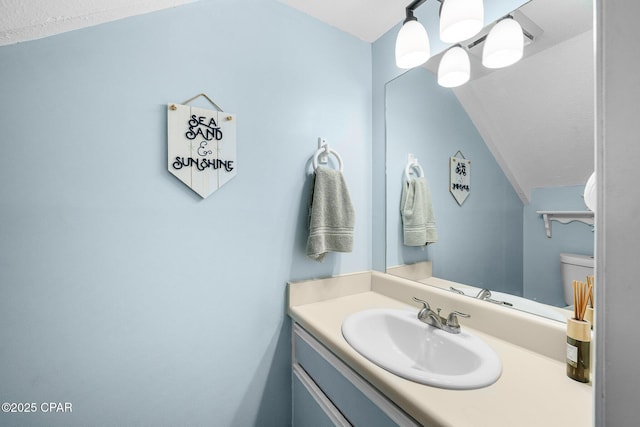 171 Damon Cir, Panama City Beach, FL 32407 - bathroom with vanity, vaulted ceiling, and toilet