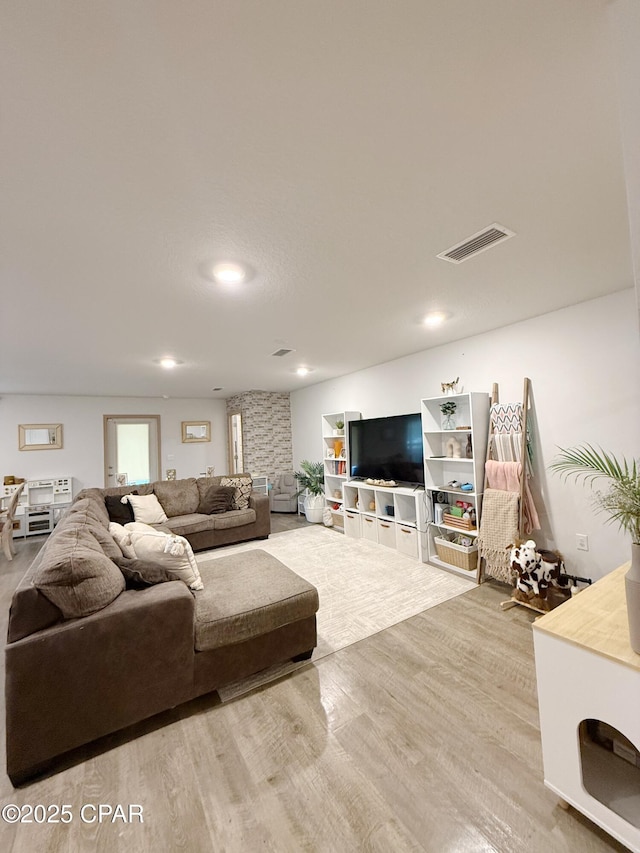 living room with visible vents and wood finished floors