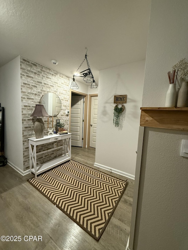 interior space featuring baseboards and wood finished floors