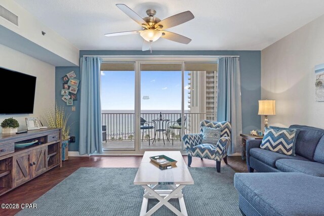 9900 S Thomas Dr Unit 819, Panama City Beach, FL 32408 - living room featuring baseboards, ceiling fan, wood finished floors, and visible vents