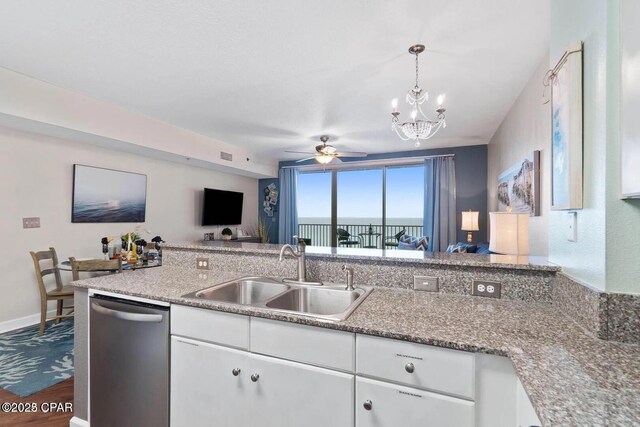 9900 S Thomas Dr Unit 819, Panama City Beach, FL 32408 - kitchen featuring a sink, dishwasher, dark wood finished floors, ceiling fan with notable chandelier, and white cabinetry