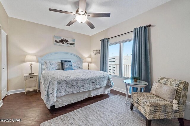9900 S Thomas Dr Unit 819, Panama City Beach, FL 32408 - bedroom featuring dark wood-style flooring, baseboards, and a ceiling fan