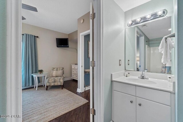 9900 S Thomas Dr Unit 819, Panama City Beach, FL 32408 - full bath featuring vanity, baseboards, and wood finished floors
