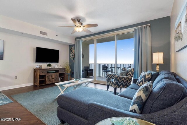 9900 S Thomas Dr Unit 819, Panama City Beach, FL 32408 - living area featuring baseboards, a ceiling fan, wood finished floors, and visible vents