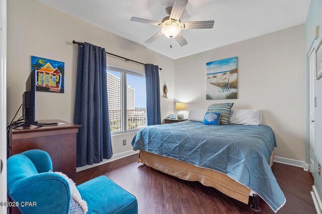 9900 S Thomas Dr Unit 819, Panama City Beach, FL 32408 - bedroom with baseboards, ceiling fan, and wood finished floors