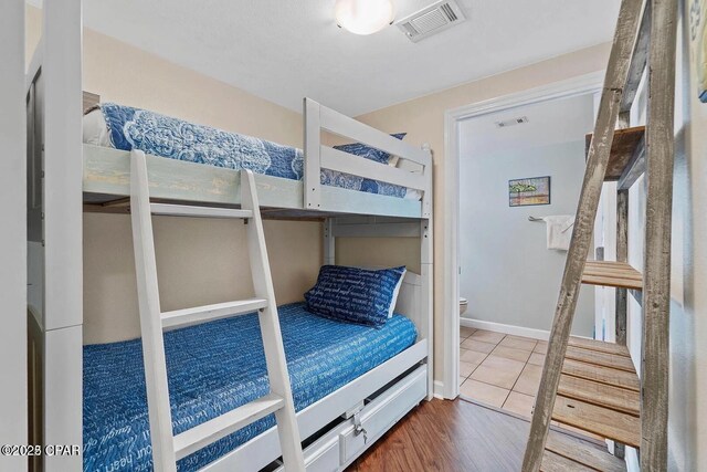 9900 S Thomas Dr Unit 819, Panama City Beach, FL 32408 - bedroom featuring visible vents and wood finished floors