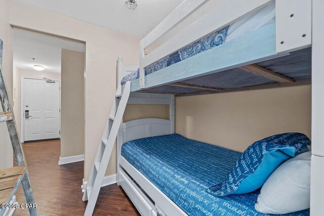 9900 S Thomas Dr Unit 819, Panama City Beach, FL 32408 - bedroom with baseboards and wood finished floors