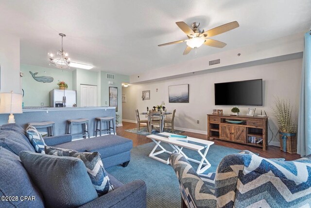 9900 S Thomas Dr Unit 819, Panama City Beach, FL 32408 - living room featuring baseboards, ceiling fan with notable chandelier, wood finished floors, and visible vents