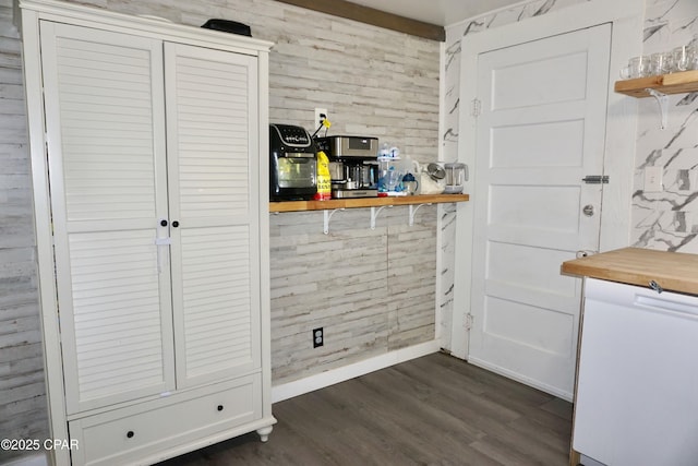 dining area with baseboards and dark wood-style floors