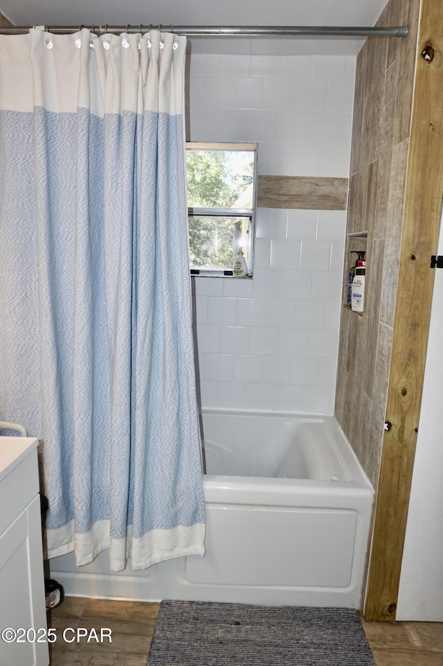 bathroom with wood finished floors, vanity, and shower / bath combination with curtain