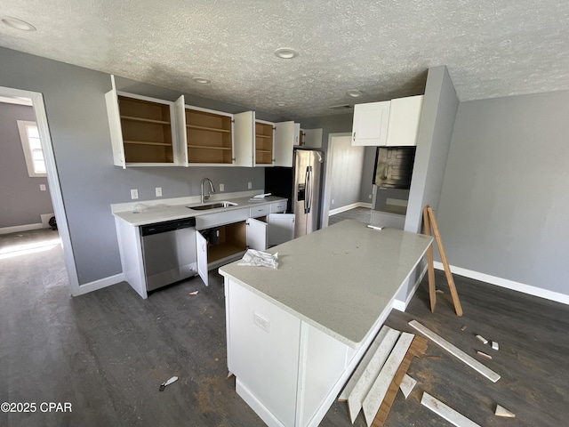 kitchen with dark wood-style flooring, a sink, stainless steel appliances, open shelves, and baseboards