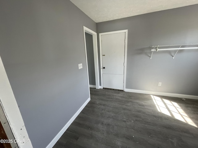 interior space featuring dark wood-style floors and baseboards