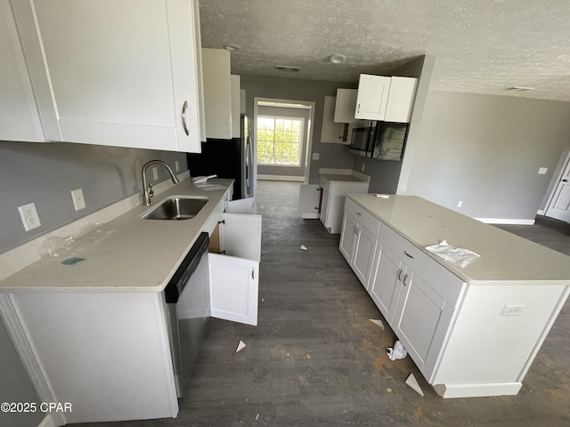 kitchen featuring white cabinetry, a sink, appliances with stainless steel finishes, and baseboards