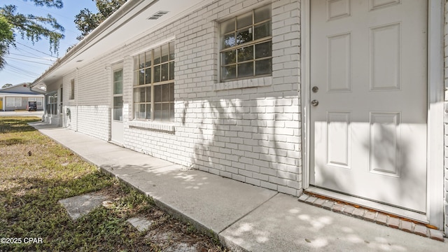 property entrance featuring brick siding