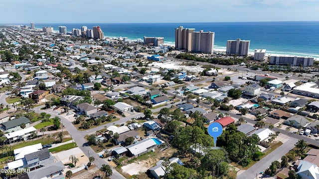 drone / aerial view featuring a view of city and a water view