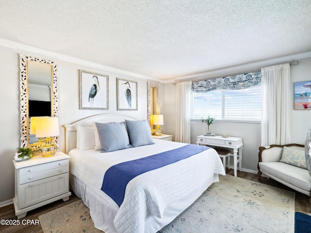 5801 Thomas Dr Unit 415, Panama City, FL 32408 - bedroom featuring wood finished floors, a textured ceiling, baseboards, and ornamental molding
