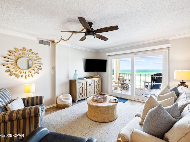 5801 Thomas Dr Unit 415, Panama City, FL 32408 - living area with a ceiling fan, wood finished floors, crown molding, and visible vents