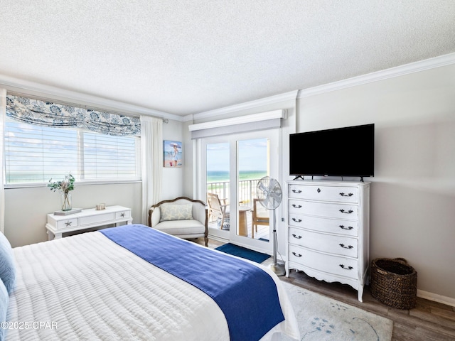 5801 Thomas Dr Unit 415, Panama City, FL 32408 - bedroom featuring crown molding, wood finished floors, access to exterior, and a textured ceiling