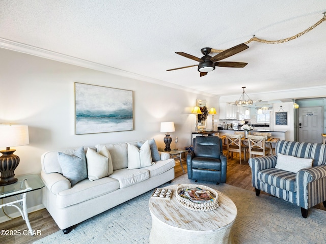 5801 Thomas Dr Unit 415, Panama City, FL 32408 - living area featuring ceiling fan with notable chandelier, wood finished floors, a textured ceiling, and crown molding