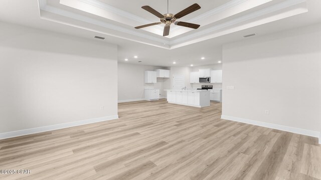 3326 Rachel Pl, Panama City, FL 32409 - unfurnished living room featuring crown molding, recessed lighting, a tray ceiling, and visible vents