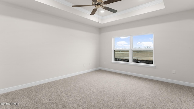 3326 Rachel Pl, Panama City, FL 32409 - spare room with crown molding, baseboards, a tray ceiling, a ceiling fan, and carpet