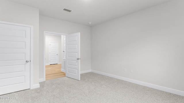 unfurnished bedroom with visible vents, carpet flooring, and baseboards
