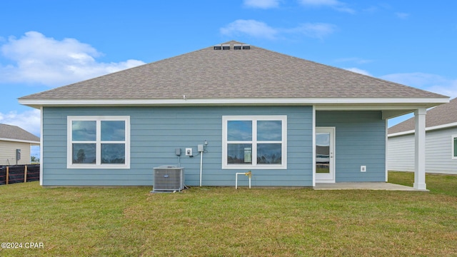 back of house with a lawn, a patio, and a shingled roof