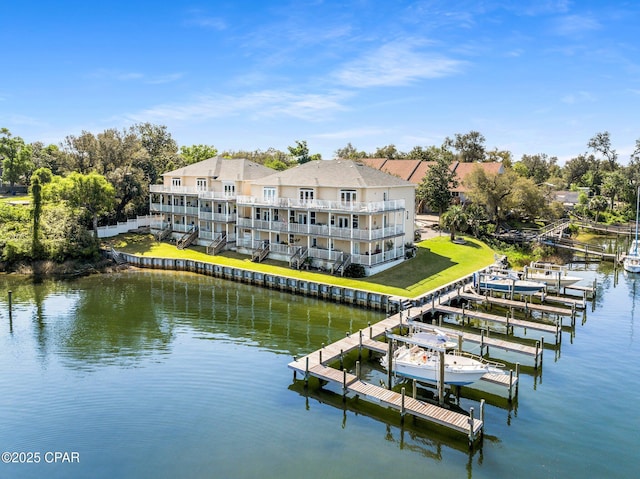view of dock with a lawn, a water view, and boat lift