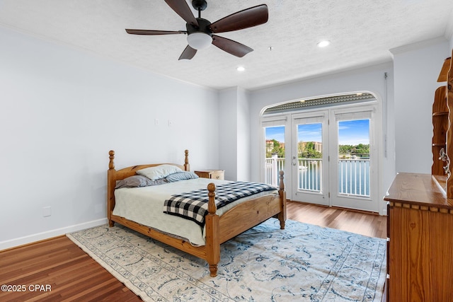 bedroom featuring wood finished floors, access to exterior, baseboards, ceiling fan, and recessed lighting