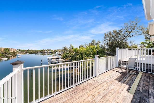 wooden terrace featuring a water view