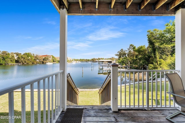wooden terrace featuring a yard and a water view