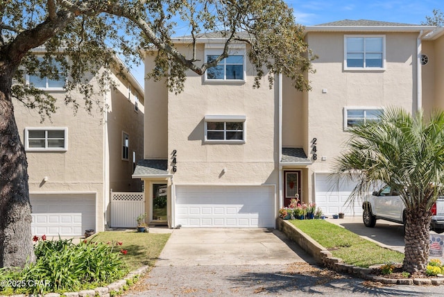 view of front of property featuring an attached garage, driveway, and stucco siding